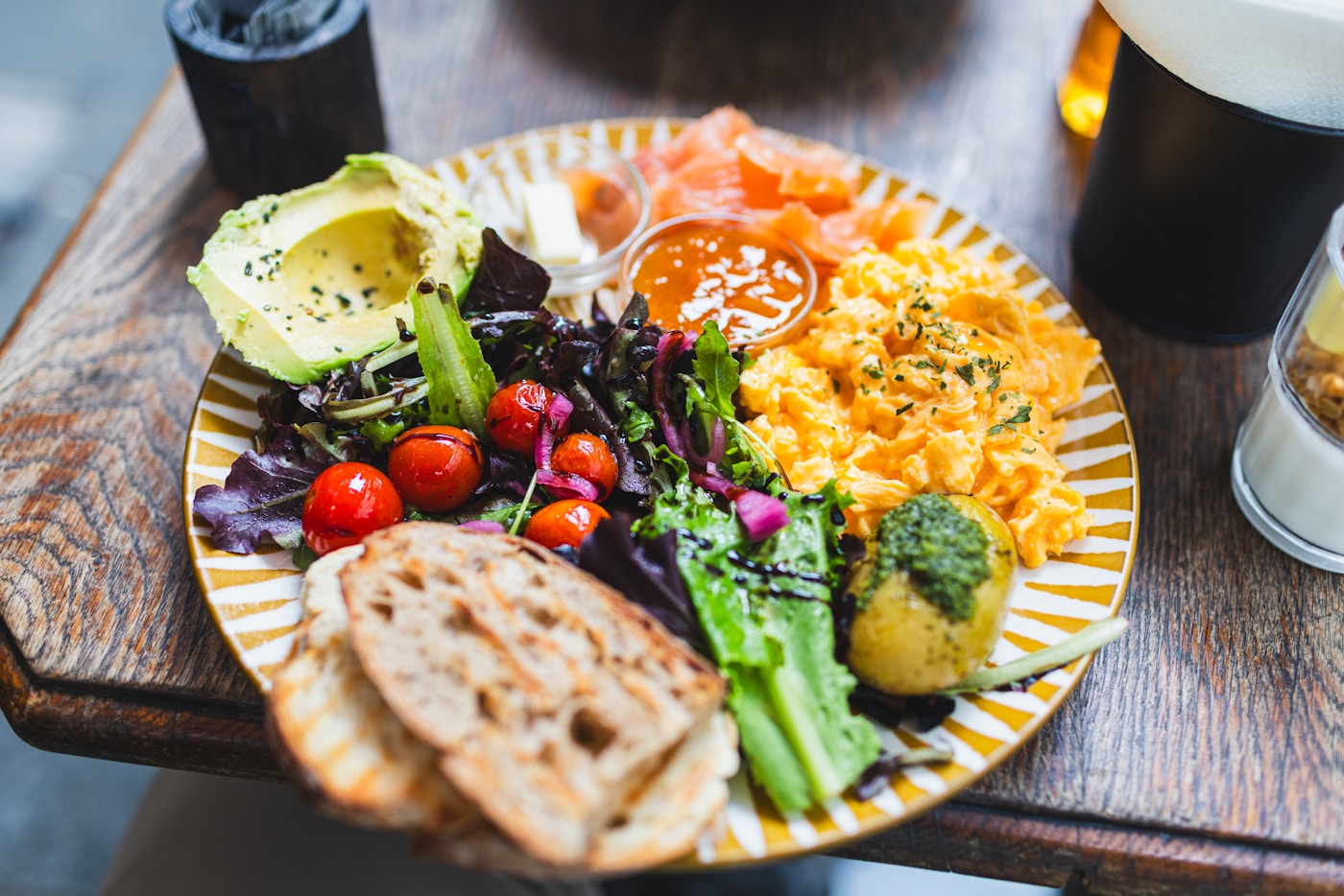 A colourful plate with eggs, avocado, salad and flatbread
