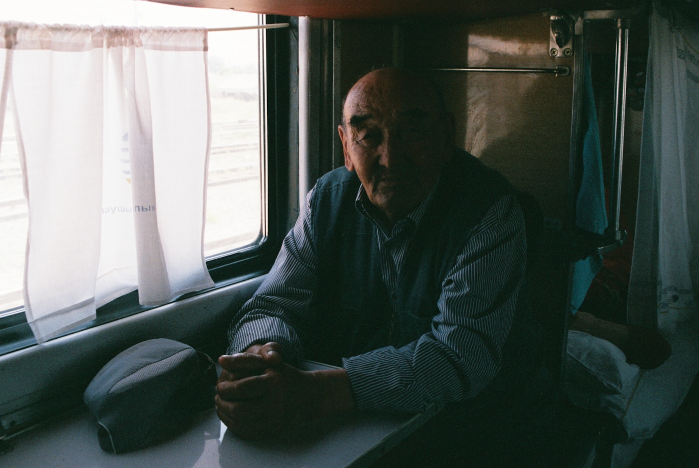 A man looking out of a train window