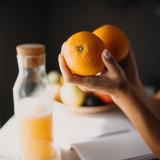 Fresh oranges and a bottle of juice